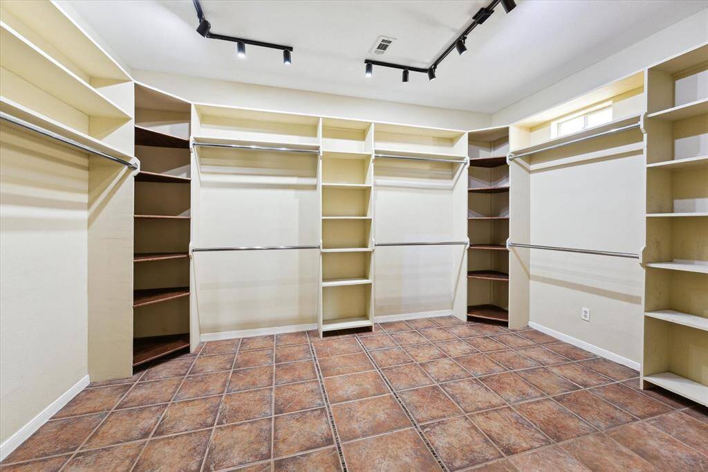 Look at this enormous closet custom designed with incredible built-ins, shelving and special lighting.