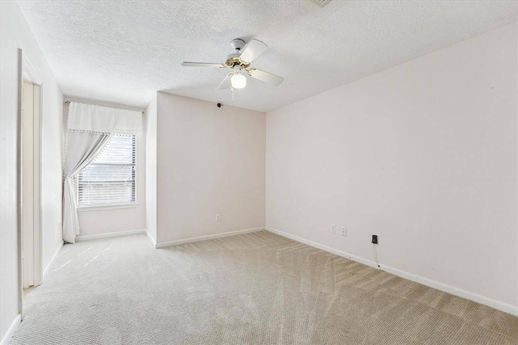 Bedroom with study nook, ceiling fan and walk-in closet. Over looks the serene backyard.