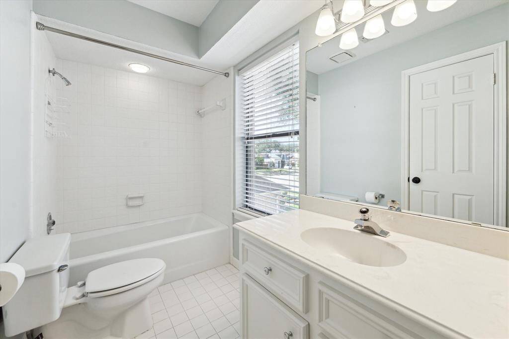 This bath has tub/shower, tile flooring and is conveniently located off of the hall for the use by the 4th bedroom and the gameroom.
