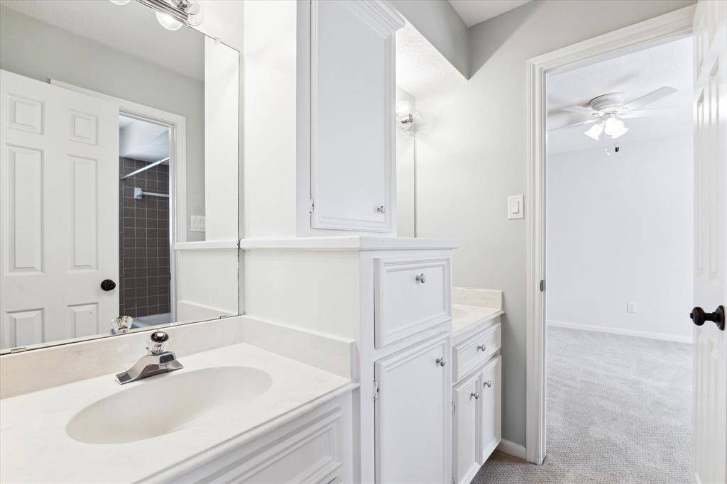The "jack and jill" bath joins the 2nd and 3rd bedrooms with double sinks and a tub/shower.