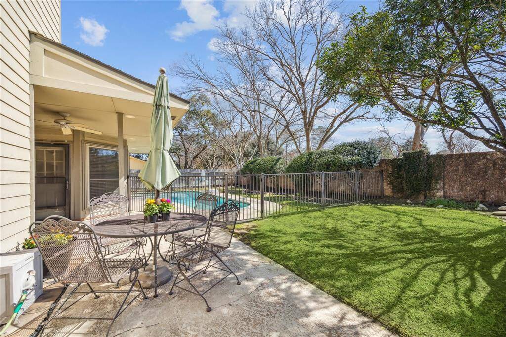 The covered patio area is great for entertaining and even incorporates a television for watching the games!What a great spot to gather and relax. Pool is fenced off for the little ones and furry friends.