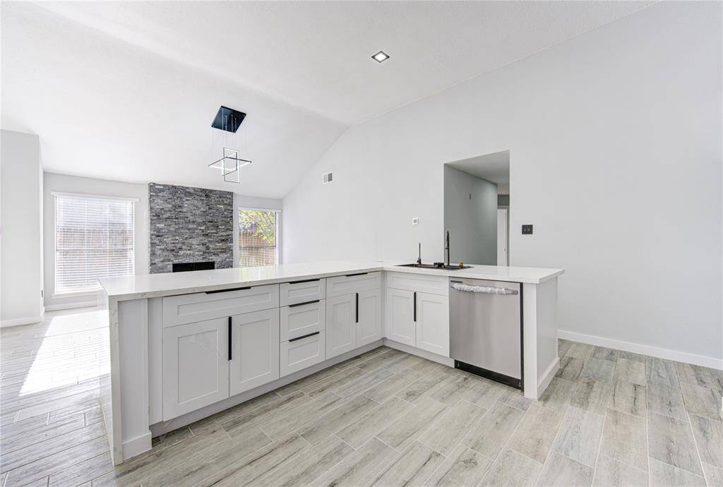 This open kitchen seamlessly connects to the family room and leads to the bedrooms, offering a perfect blend of style and functionality.