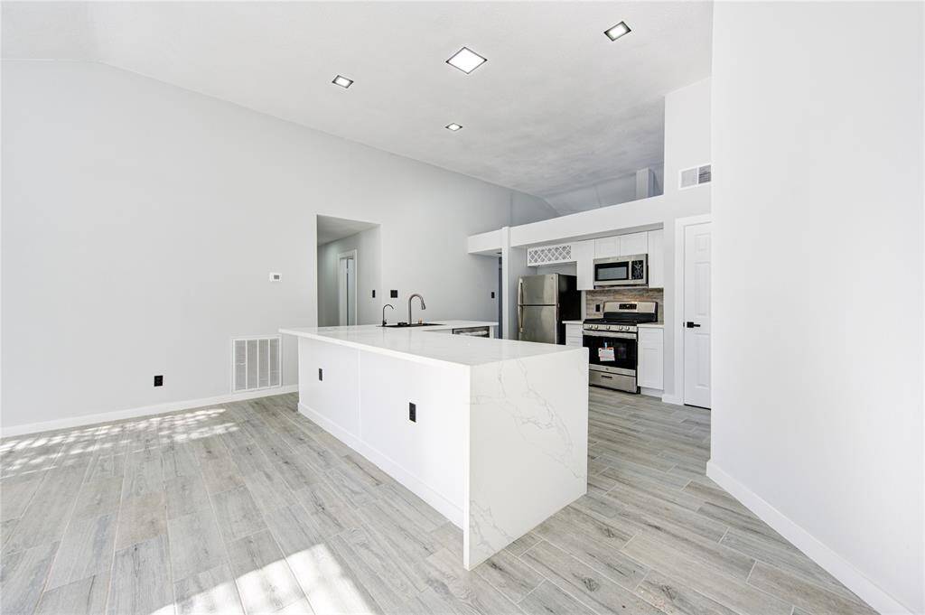 Spacious, modern kitchen with sleek finishes and ample natural light, perfect for entertaining.