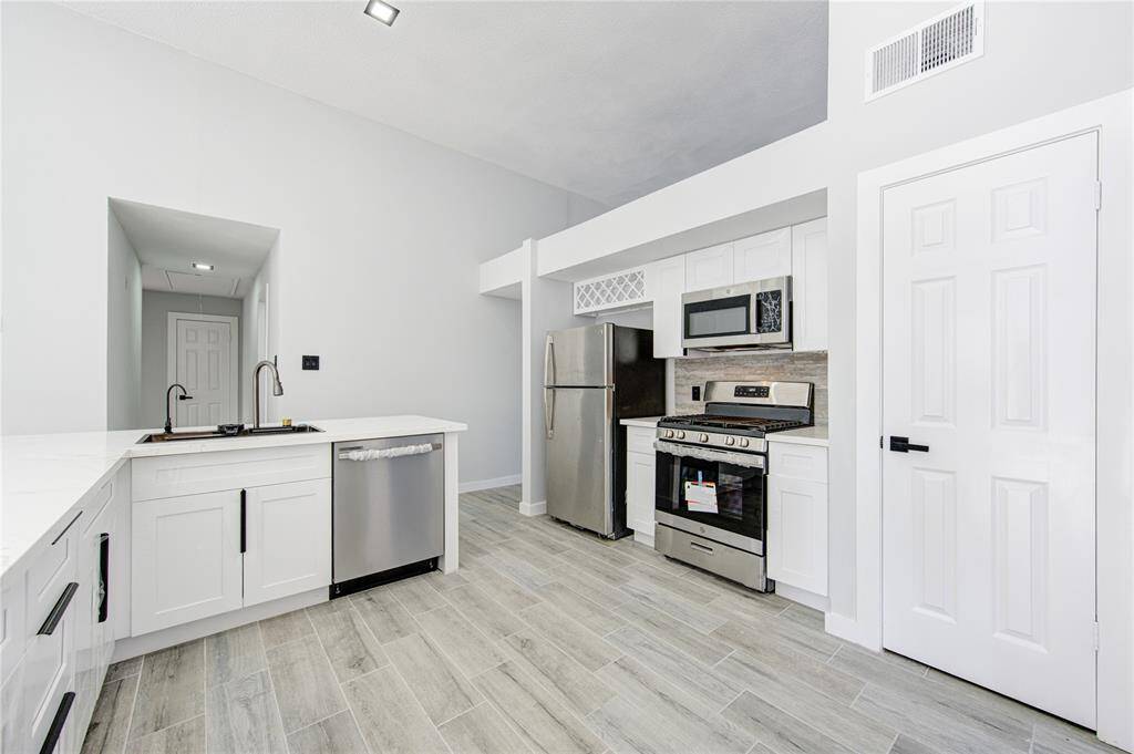 Featuring brand-new lighting and modern appliances.