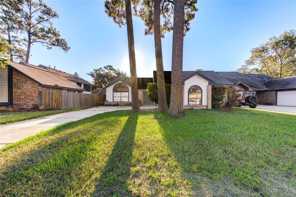 Charming home with a welcoming facade, set amidst mature trees and lush greenery. The spacious driveway and elegant windows enhance its curb appeal. Perfect for those seeking a blend of comfort and style.