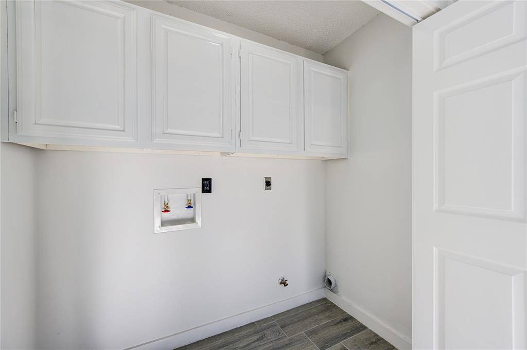 Conveniently located adjacent to the kitchen, this utility room offers practical functionality and easy access.