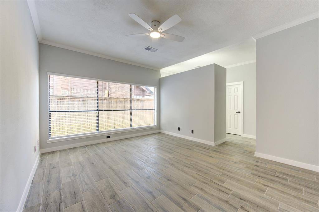 Spacious primary room with abundant natural light from large windows.