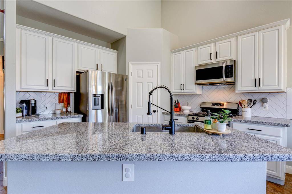 Note the walk-in pantry behind the tasteful, new kitchen faucet!