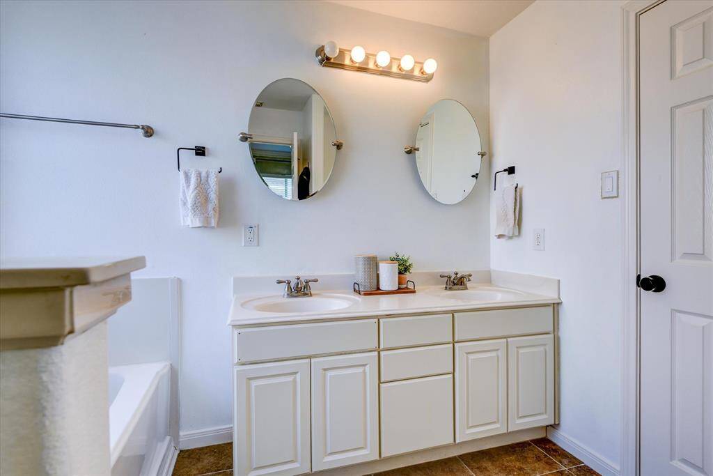 Plenty of counter space, two sinks, and individual mirrors leave everyone room to prepare for the day!