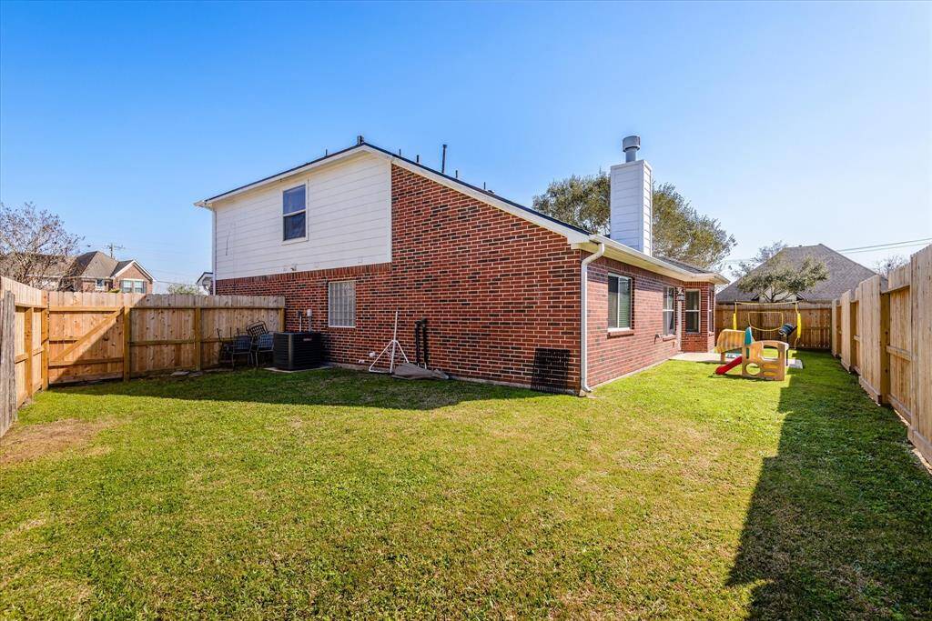 Fully fenced backyard is much larger than appears! Room for a trampoline or playset!