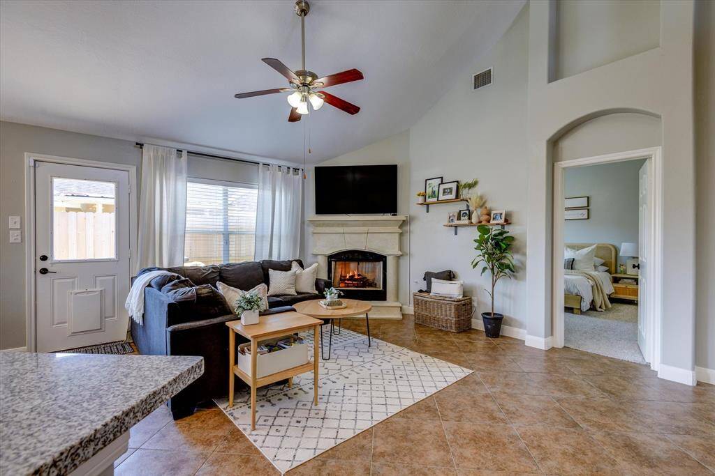 High ceilings with a living room centered around a cozy gaslog fireplace!
