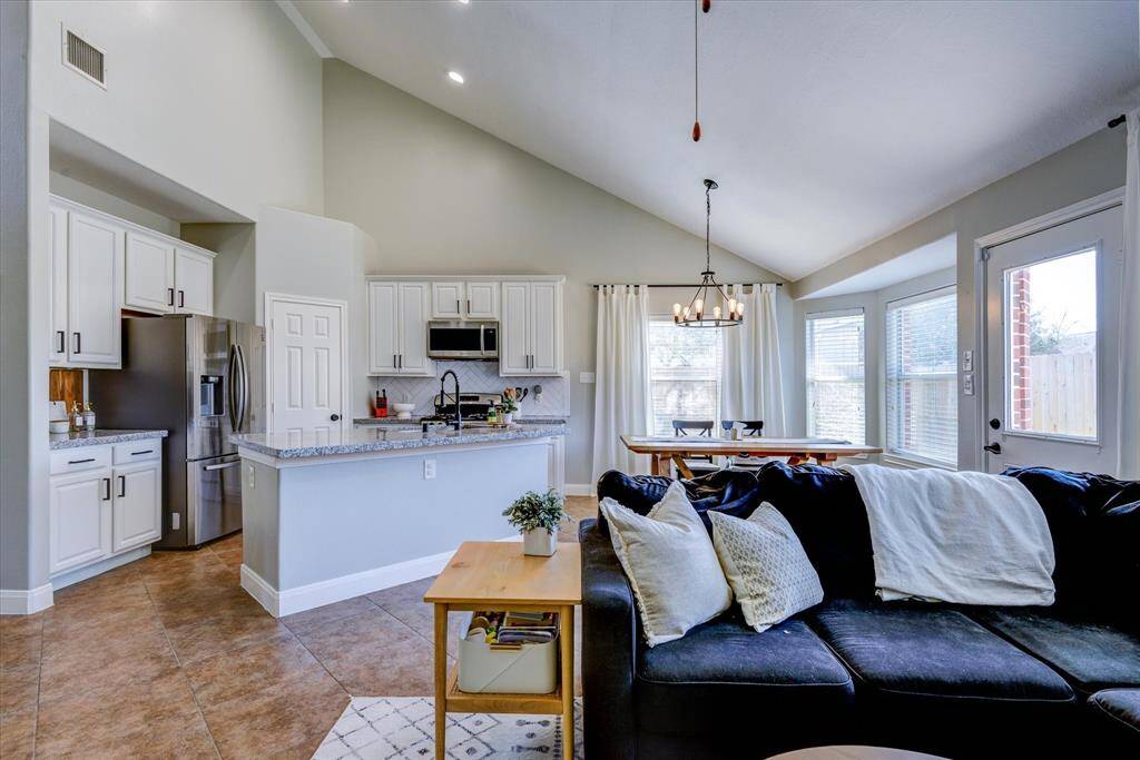 A view into the large kitchen from the living room; note the bar has been dropped down to counter height so that everyone can talk and enjoy company!