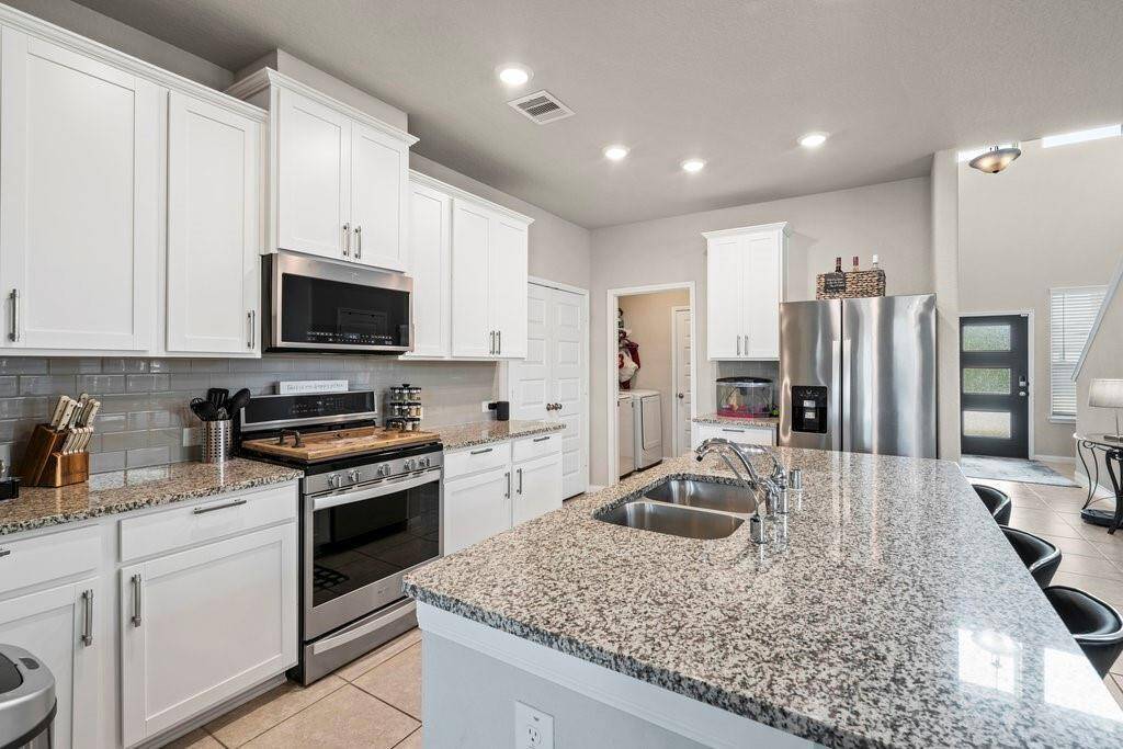 Island sink in the kitchen which makes for extra counter space.