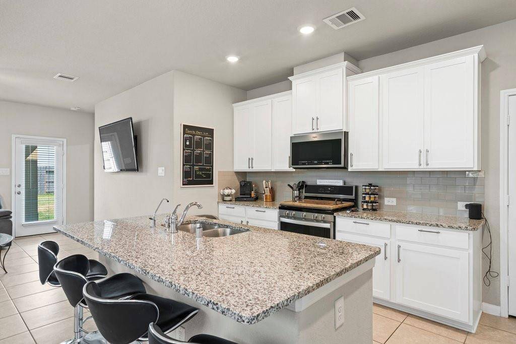 Granite Countertops with bar seating area for four.