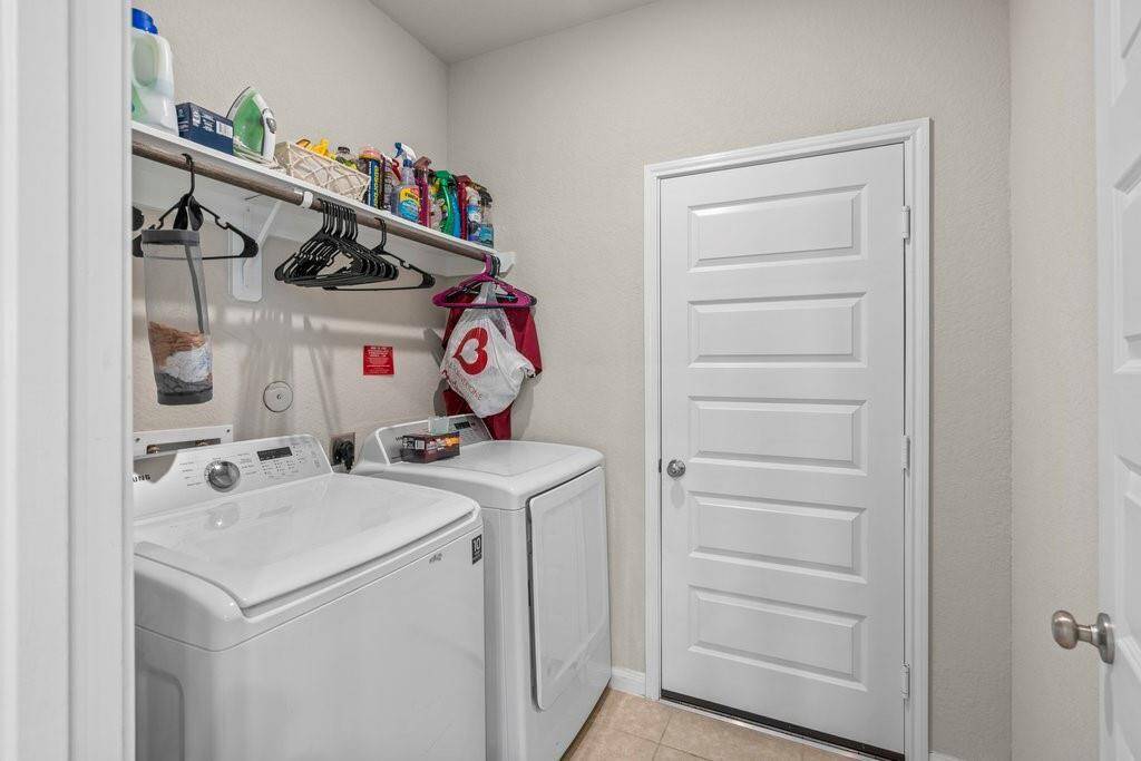 Laundry room with shelf and rod for hanging laundry.