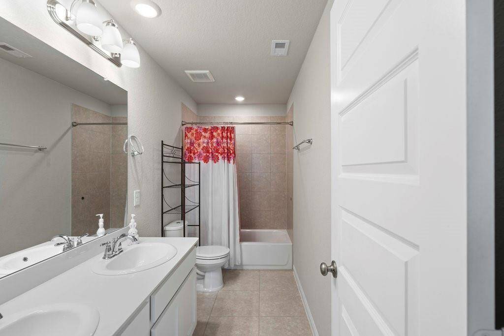Guest bathroom on the second floor also has double sinks.