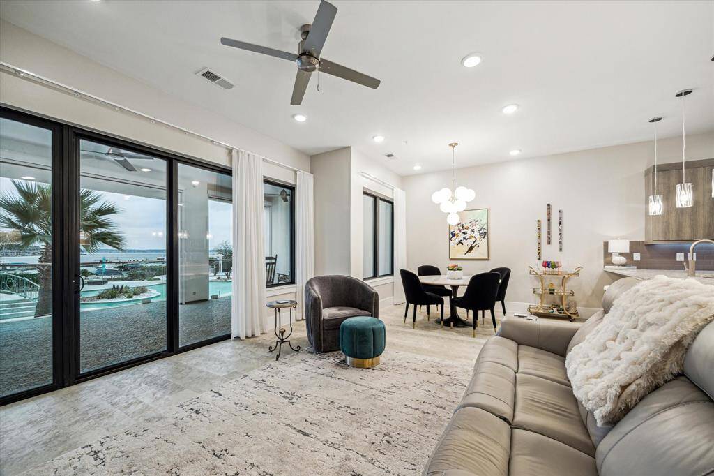 Abundant windows with waterfront views connect the spacious living and dining areas with the covered balcony.