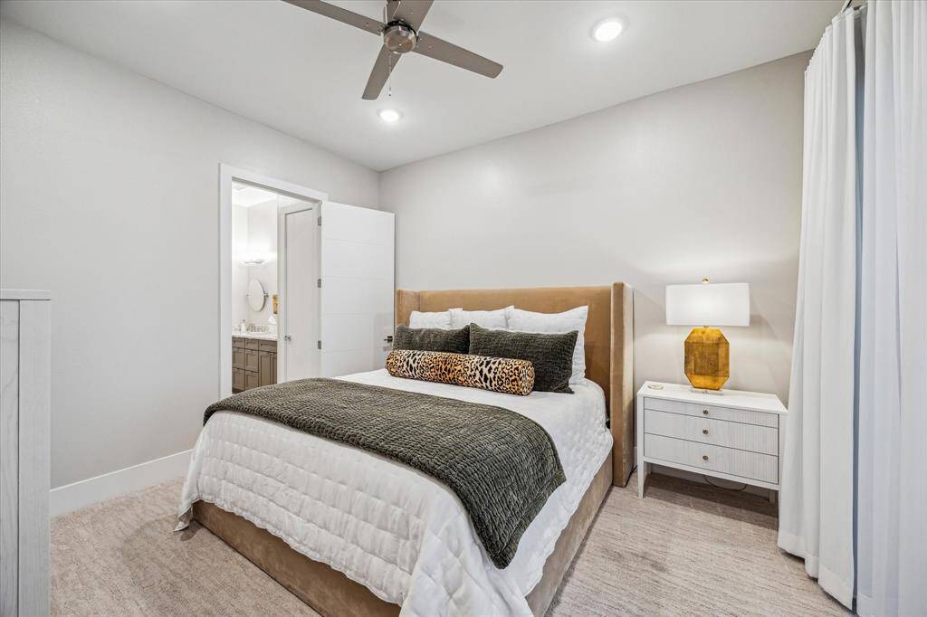 You may never want to leave this peaceful primary bedroom with lakefront views.