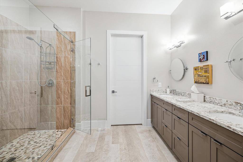 The primary en suite bathroom is gorgeous with oversize walk-in shower and double vanity.