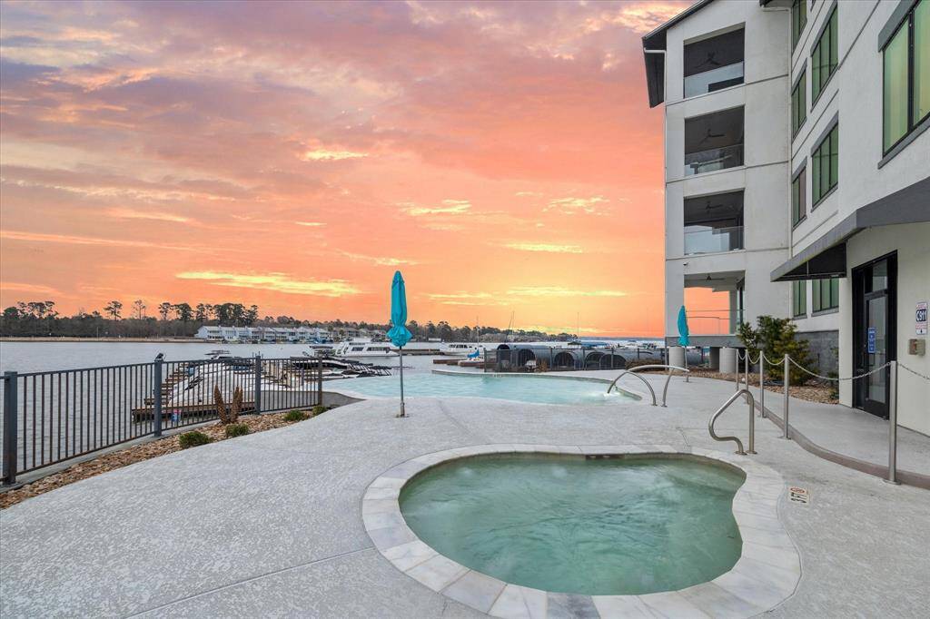 Picture yourself relaxing in a luxurious hot tub, overlooking a serene lake, where the gentle ripples of the water and the surrounding natural beauty create a perfect oasis of tranquility.