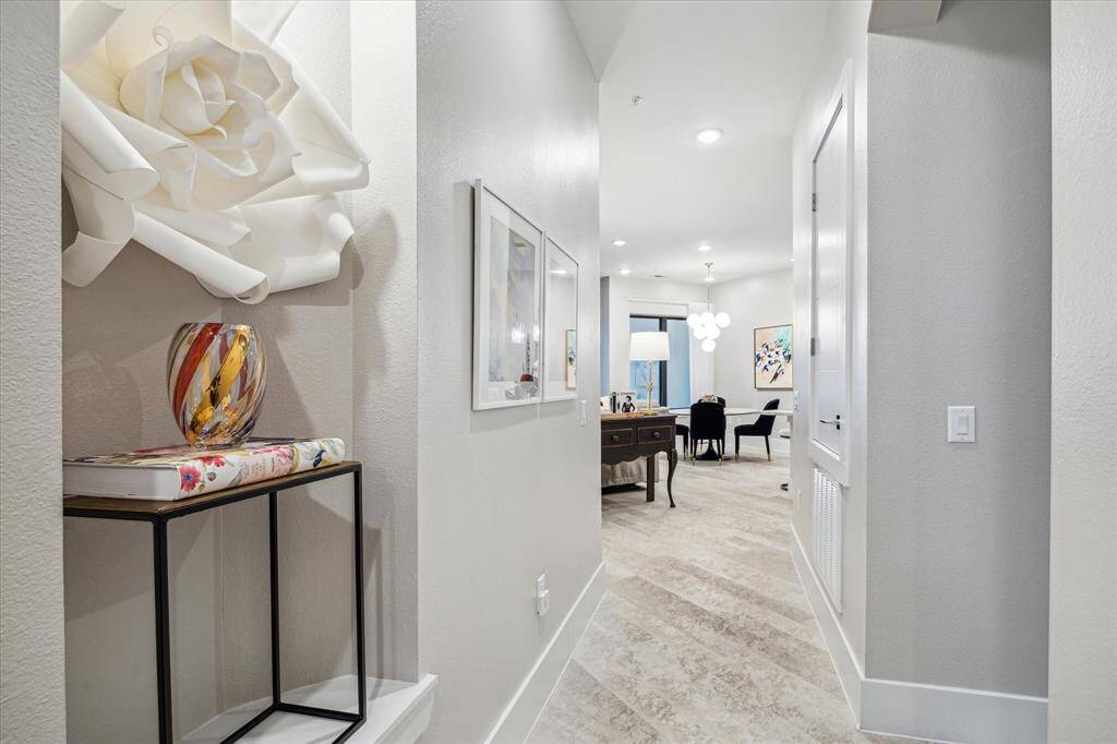 Airy interior with neutral palette, art niches, light floors and custom lighting.