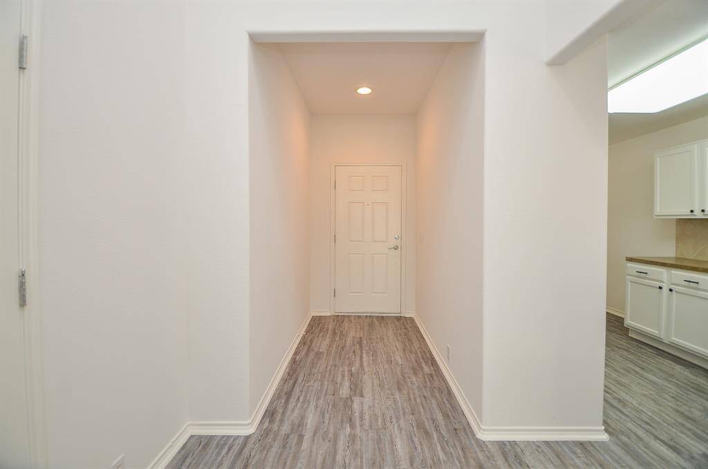 Entry hallway that leads into an open concept home.