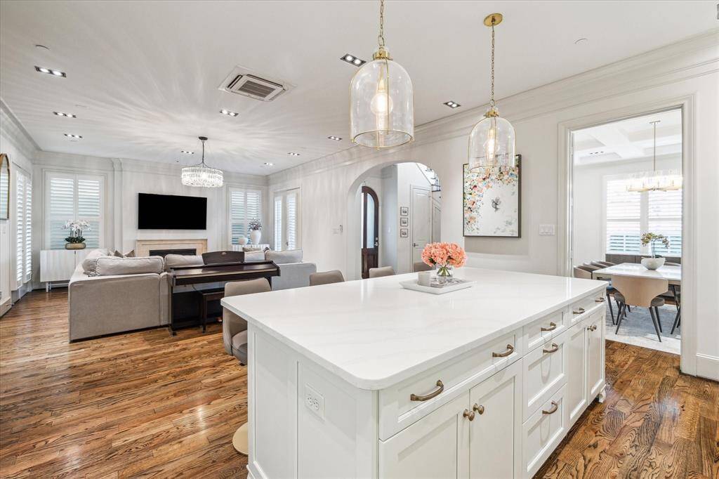 Gorgeous quartz island overlooks the Den/Family Room. Island contains storage cabinets on both sides and barstool seating.