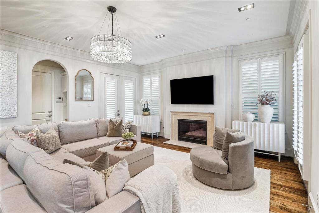 An alternate view of the Den with fireplace, wood floors, and beautiful space.