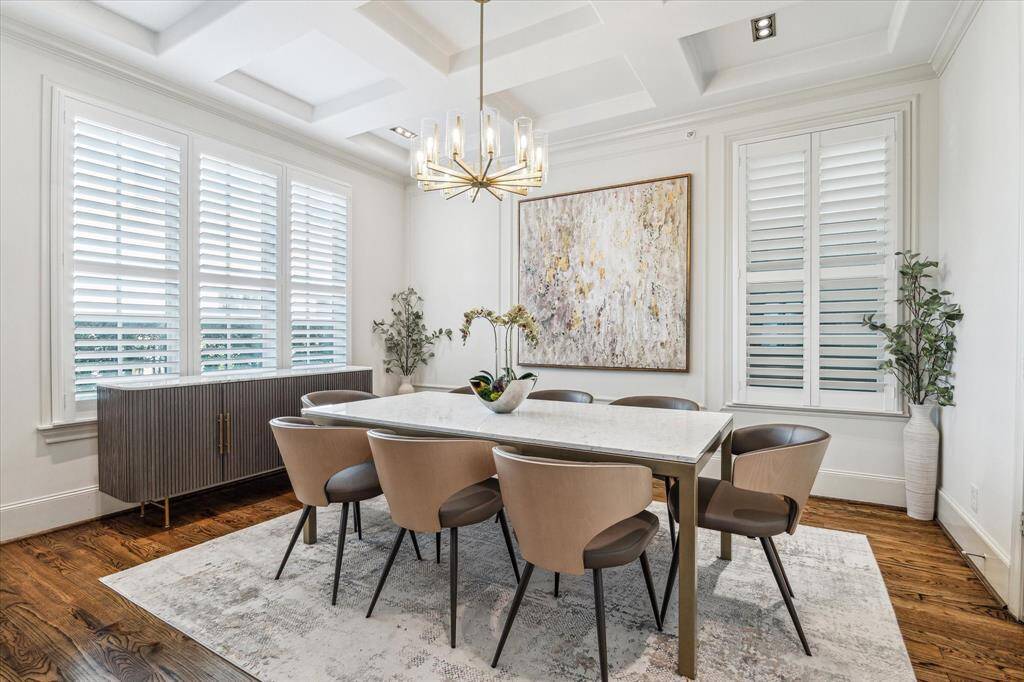 Dining Room is lovely with recent chandelier, wood floors, plantation shutters. Enjoy family meals and entertaining while overlooking the pool!