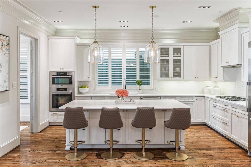 Gourmet Kitchen Updated by Sellers: recent quartz countertops, backsplash, and plumbing fixtures are beautiful. Miele appliances are top notch and include double ovens, rangetop and venthood, and built-in refrigerator.