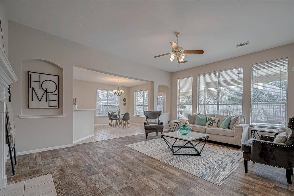 Step into your spacious living area, where oversized windows flood the room with natural light and offer a beautiful view of the backyard. The open-concept design seamlessly connects to the kitchen and breakfast room, making it easy to entertain or enjoy quiet moments with loved ones. With stylish flooring, a cozy fireplace, and plenty of room to relax, this space is designed to be the heart of your home!