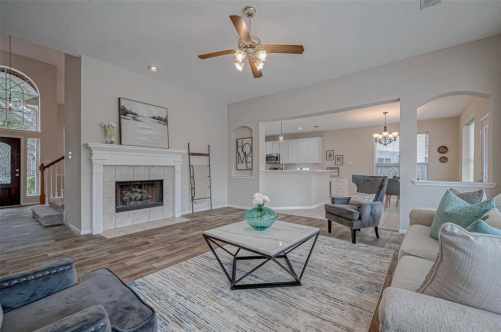 This inviting family room welcomes you with its soft neutral tones, warm flooring, and elegant fireplace. The serene ambiance makes it the perfect place to unwind after a long drive. Whether you're cozying up by the fire or enjoying a conversation with loved ones, this beautifully designed space offers both comfort and effortless relaxation.