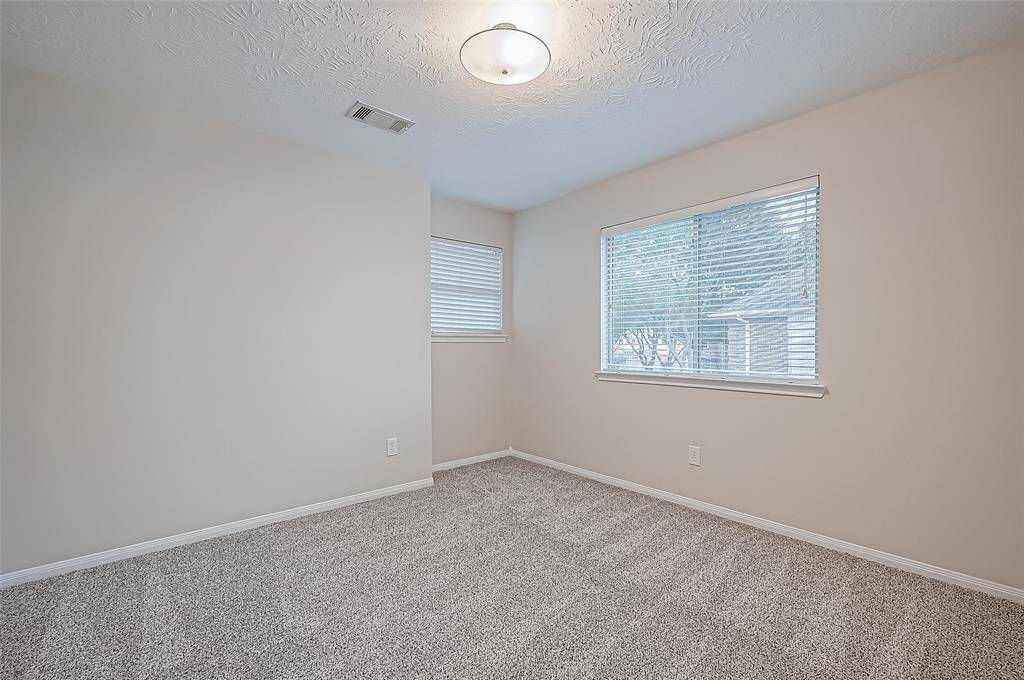 Step into a guest room that boasts plush carpeting and an abundance of natural light from thoughtfully placed windows, creating a warm and comfortable retreat for your visitors.