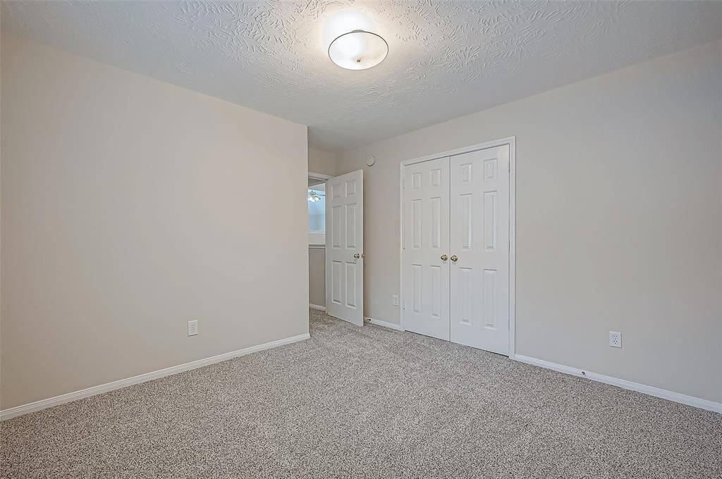 Enjoy the comfort of this spacious guest room featuring a generous layout and a convenient double-door closet, perfect for keeping everything neatly tucked away.
