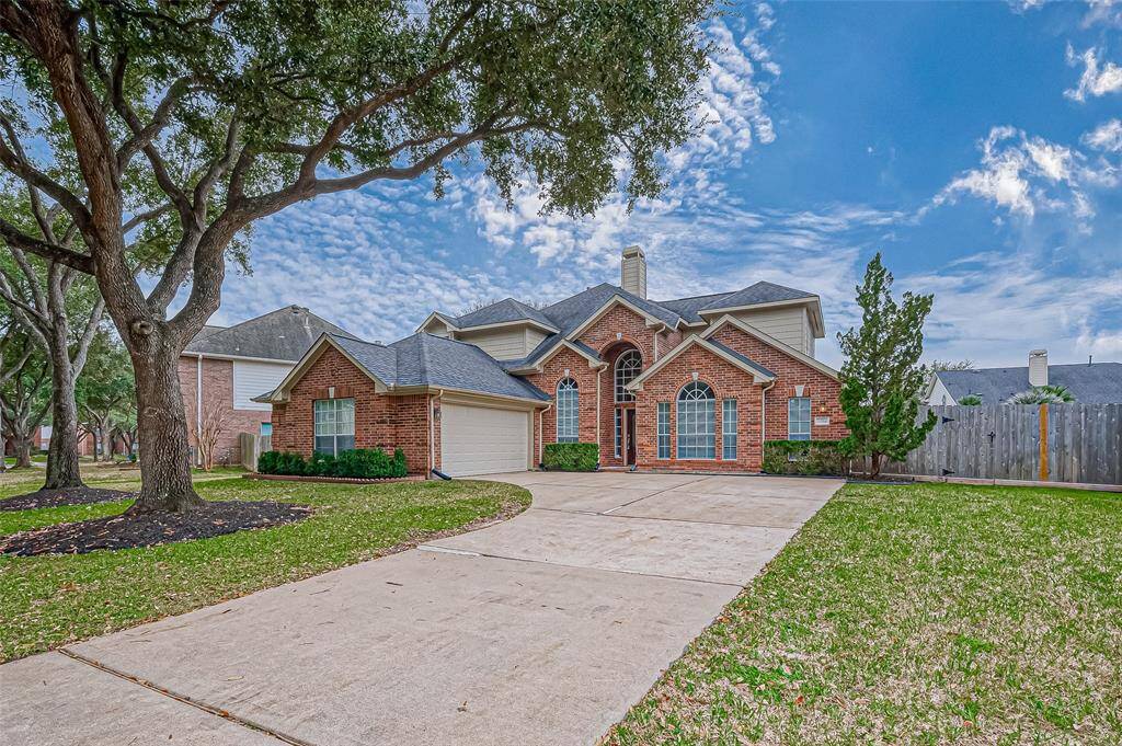 As you drive up, the 100' of curb appeal with mature trees immediately welcomes you to this elegant brick home. The striking arched windows and soaring entryway set the tone for the warmth and sophistication you’ll experience inside. This soon-to-be-yours home offers a spacious driveway, beautifully manicured landscaping, and a timeless design that feels both inviting and impressive.