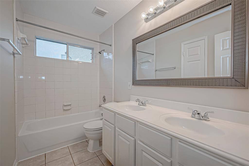 Morning routines become easy in this beautifully designed bathroom, where a dual-sink vanity lets you start your day side by side without a wait. A refreshing retreat to unwind and recharge.