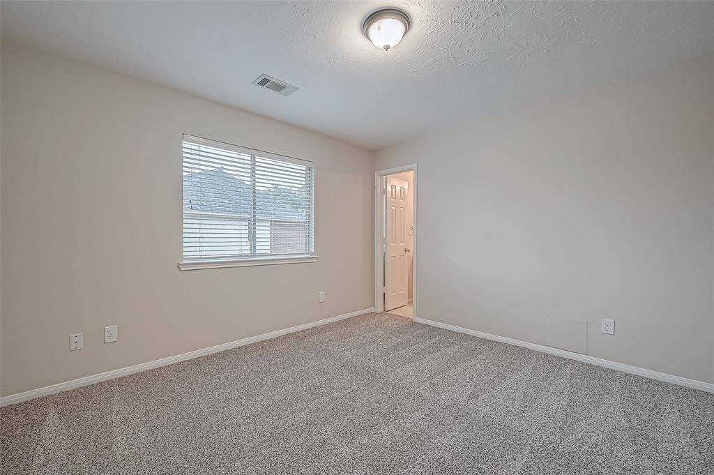 This guest room is designed for comfort with its large window, roomy closet and plush carpet.