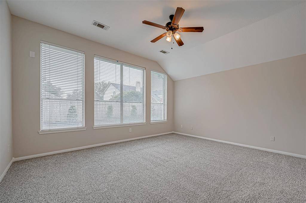 This bright and airy primary bedroom is the perfect retreat, offering plenty of space and natural light to create a cozy, personal haven. With large windows, a ceiling fan, and a versatile layout, you can easily make this room a peaceful escape.