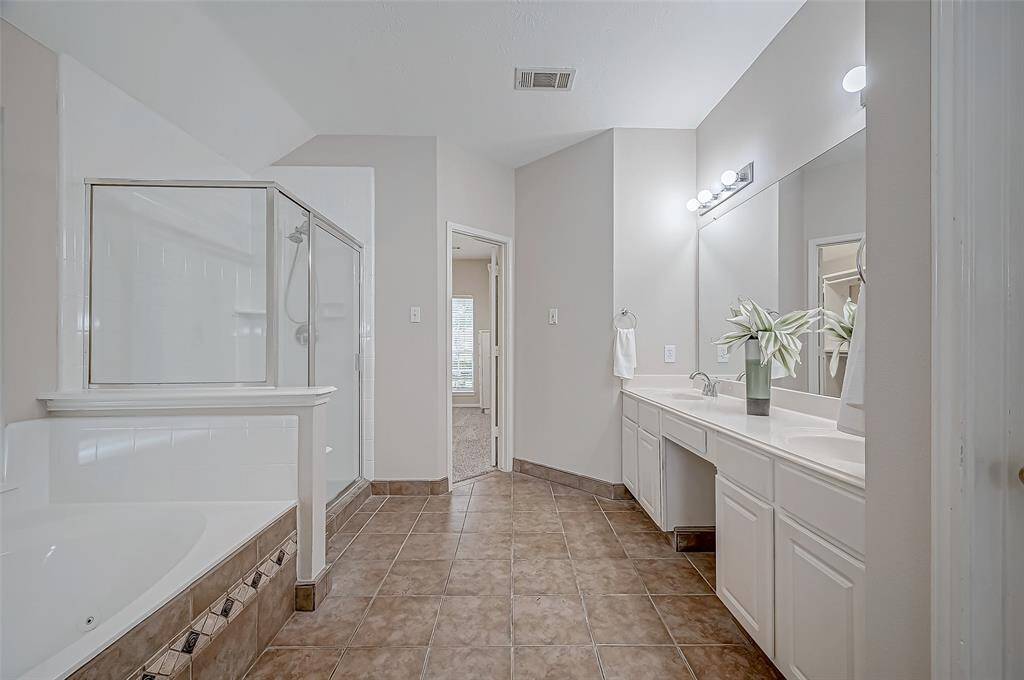 A stunning ensuite bathroom offers everything you need for relaxation and functionality, featuring a spacious walk-in shower, a luxurious soaking tub, and an expansive double vanity. With its bright lighting, elegant finishes, and plenty of counter space, you can start and end your day in pure comfort and style.