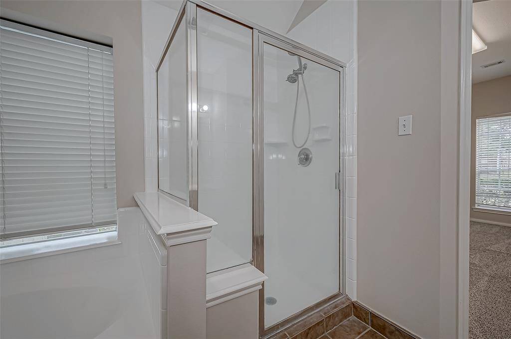Step into your spacious glass-enclosed shower, where sleek design meets everyday convenience, giving you plenty of room to unwind. With built-in shelves for your essentials and a bright, open feel, this shower transforms your daily routine into a refreshing experience.