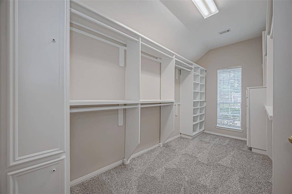 This is your custom walk-in closet that offers you the perfect space to keep everything organized, from your wardrobe to your favorite accessories. With built-in shelving, abundant hanging space, and natural light pouring in, getting ready each day will feel effortless and enjoyable!