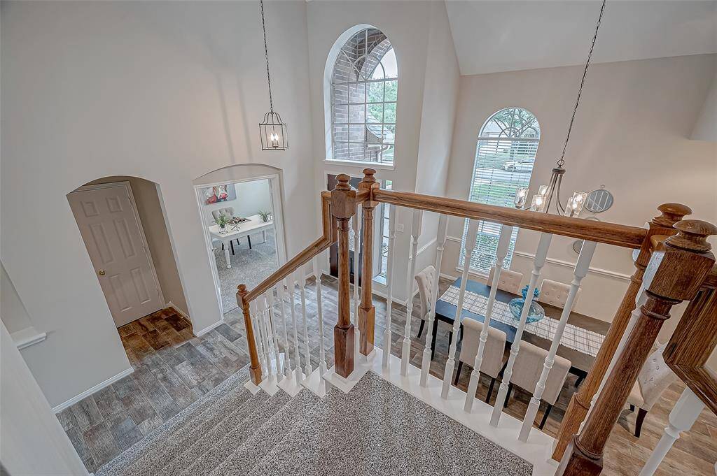 From the staircase landing, seamlessly connect to the rest of this bright, open home, where natural light and spacious design create a warm and welcoming flow.