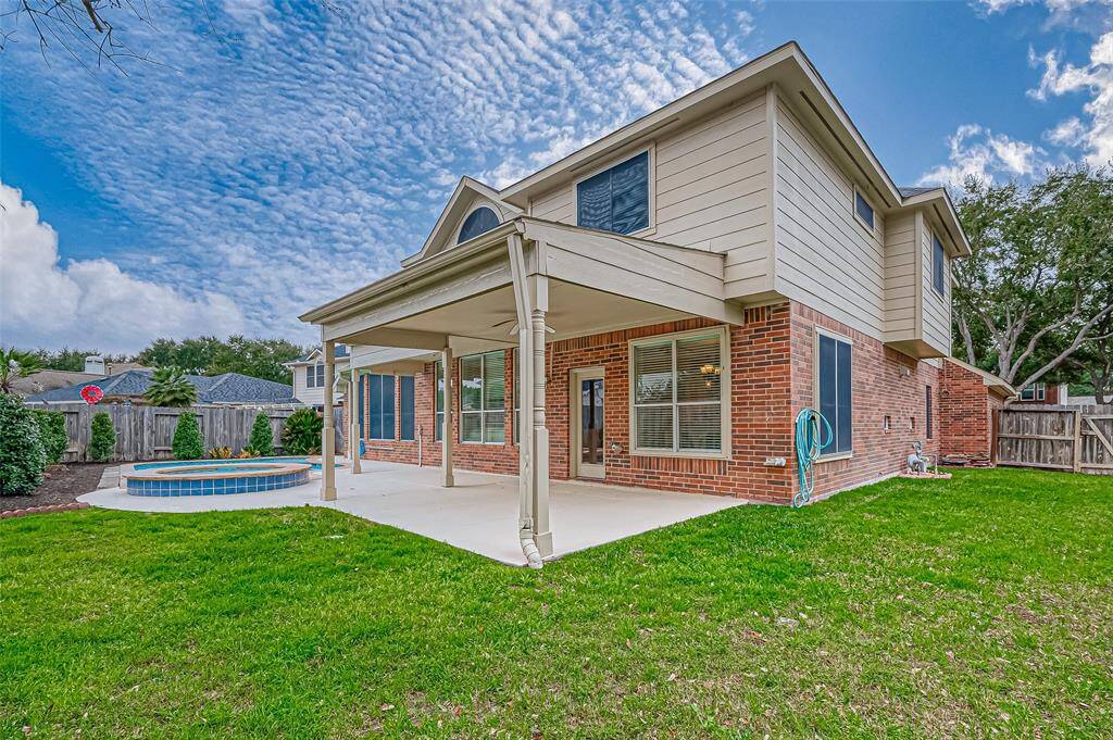 Your backyard is designed for both relaxation and practicality, with a spacious lawn that gives you endless possibilities for play, gardening, or simply unwinding.