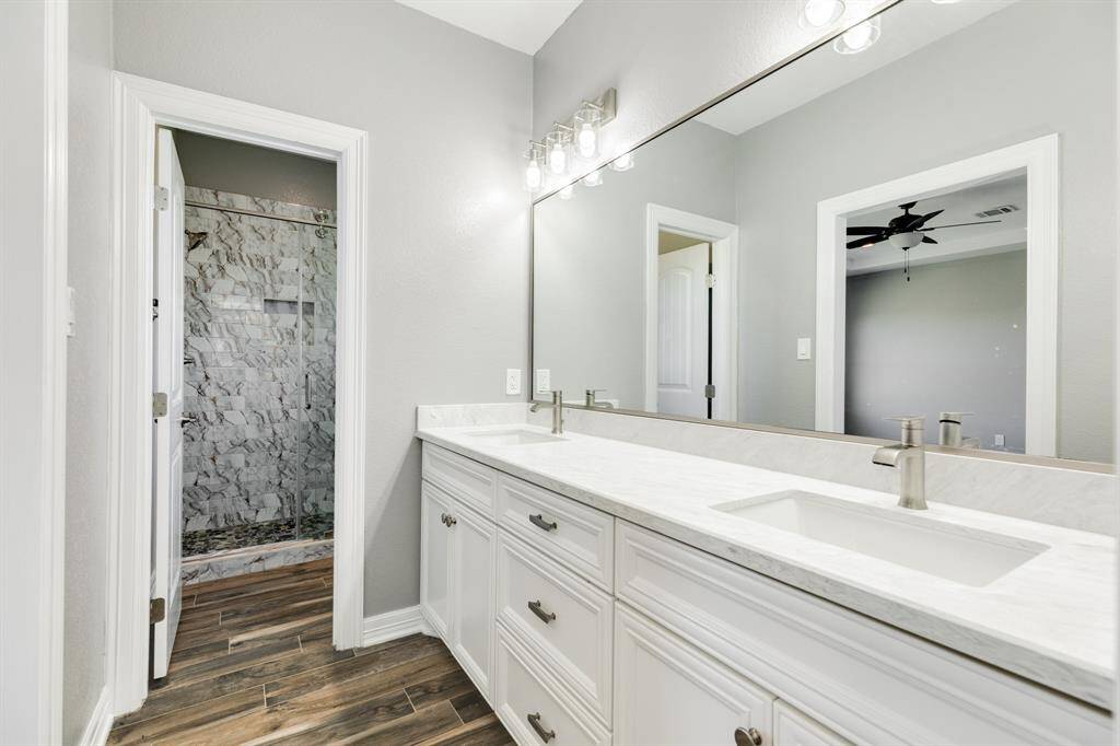 Primary Bathroom with Double Vanities and a Walk In Shower