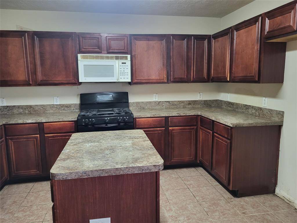 Kitchen displaying cabinets and countertops.