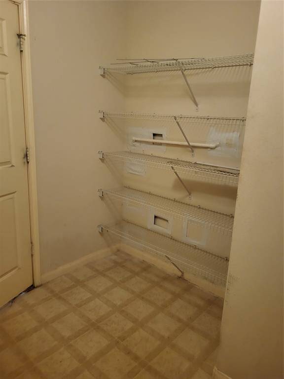 Laundry room very large with ample space and shelving and storage