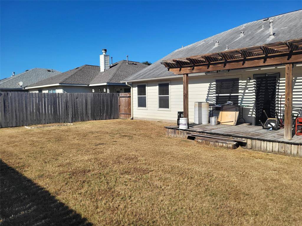 Huge backyard with deck perfect for backyard barbeques and for kids to run and play