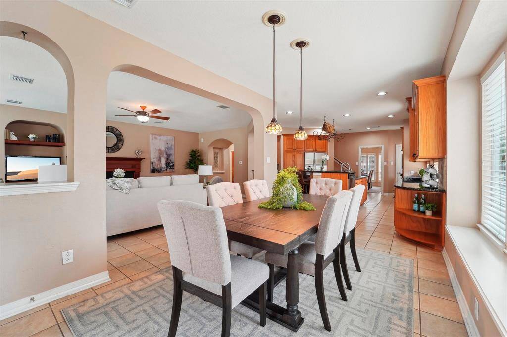 Enjoy Wednesday night lasagna or Saturday morning pancakes in this charming breakfast area with tile flooring and stylish lighting.