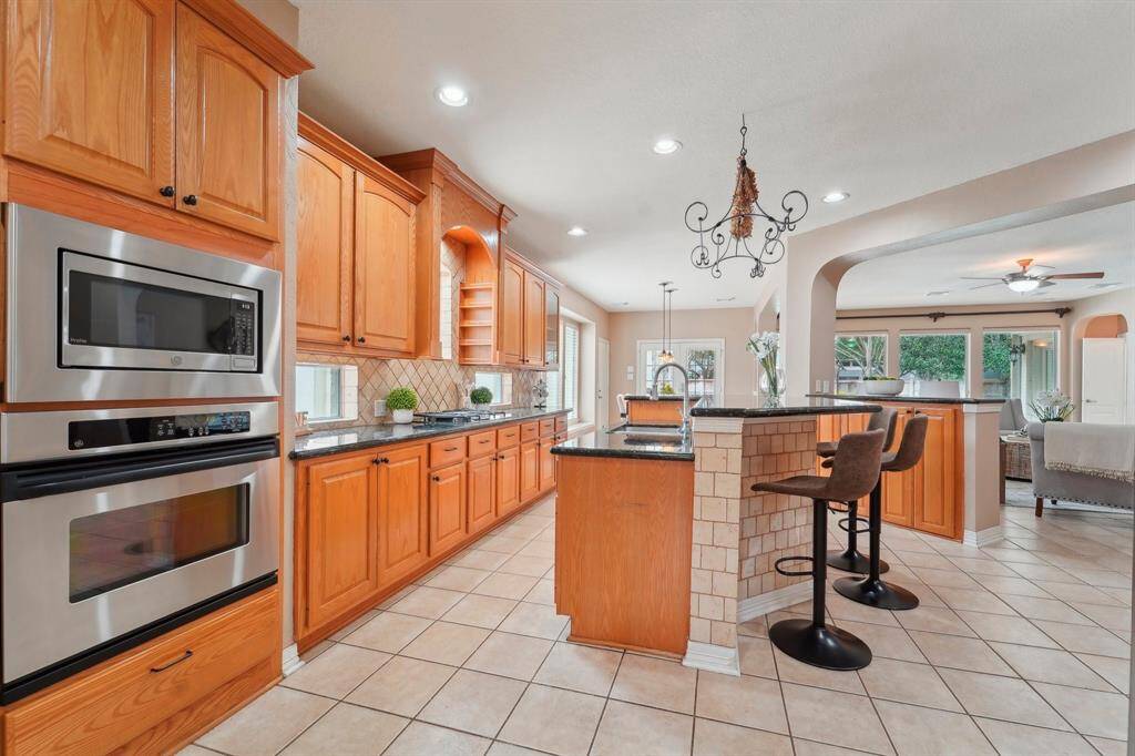 Ditch the takeout for home-cooked meals with the help of this immaculate island kitchen! Fully loaded with built-in stainless steel appliances, abundant cabinetry, sleek granite countertops, and a very large walk-in pantry.