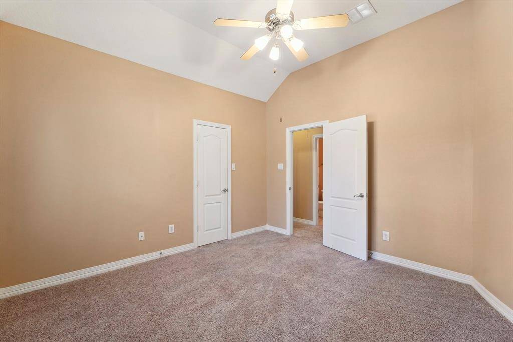 An alternate view of the spacious guest bedroom shows plenty of floor space for furniture, games, toys, and more and a large walk-in closet.
